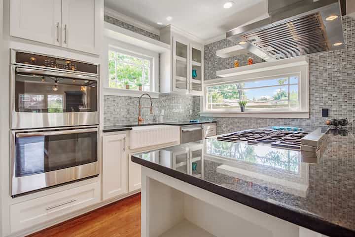 An image of a modern kitchen with sleek appliances, featuring a gas stove, refrigerator, and built-in microwave in Sterling